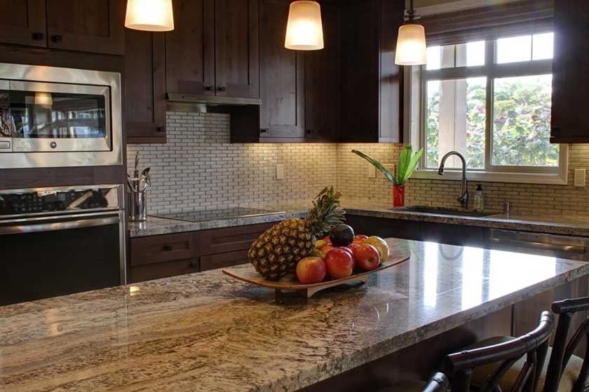 white and grey lining countertop with fruits in a dish.