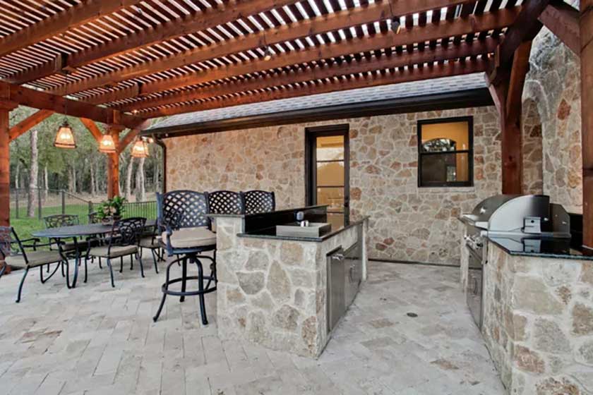 stone walls and wooden roof with grill and marble countertop