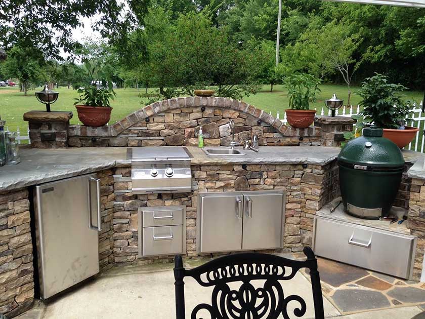 rock outdoor kitchen with steel cabinets