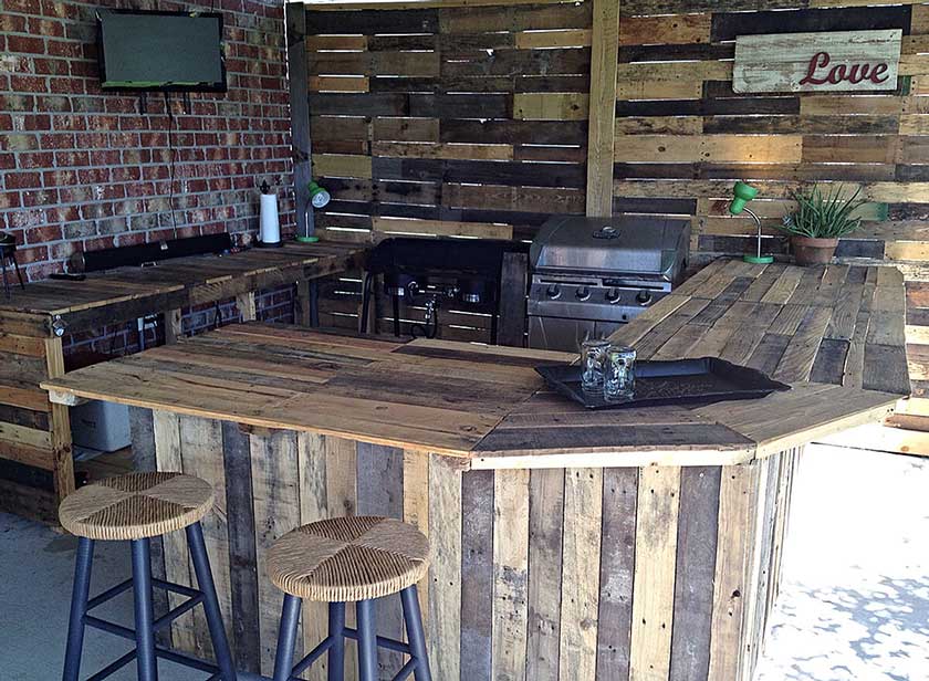 outdoor kitchen with wood countertop and cabinets