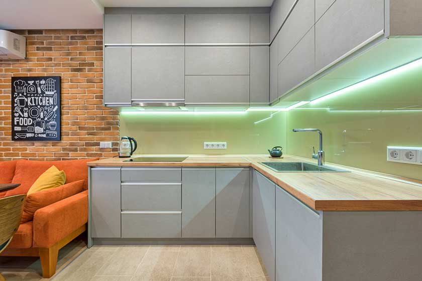 grey floating kitchen cabinets with green neon light below