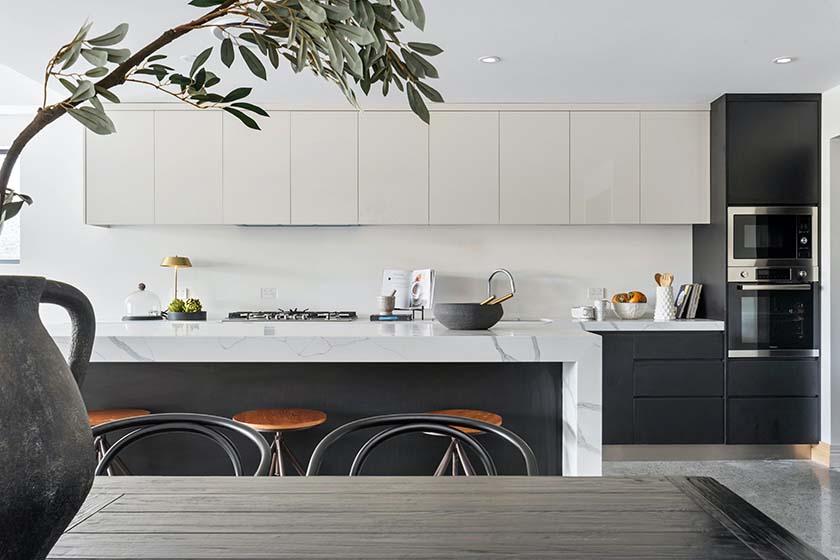 Black and white finished modern kitchen design with floating kitchen cabinets and countertops 